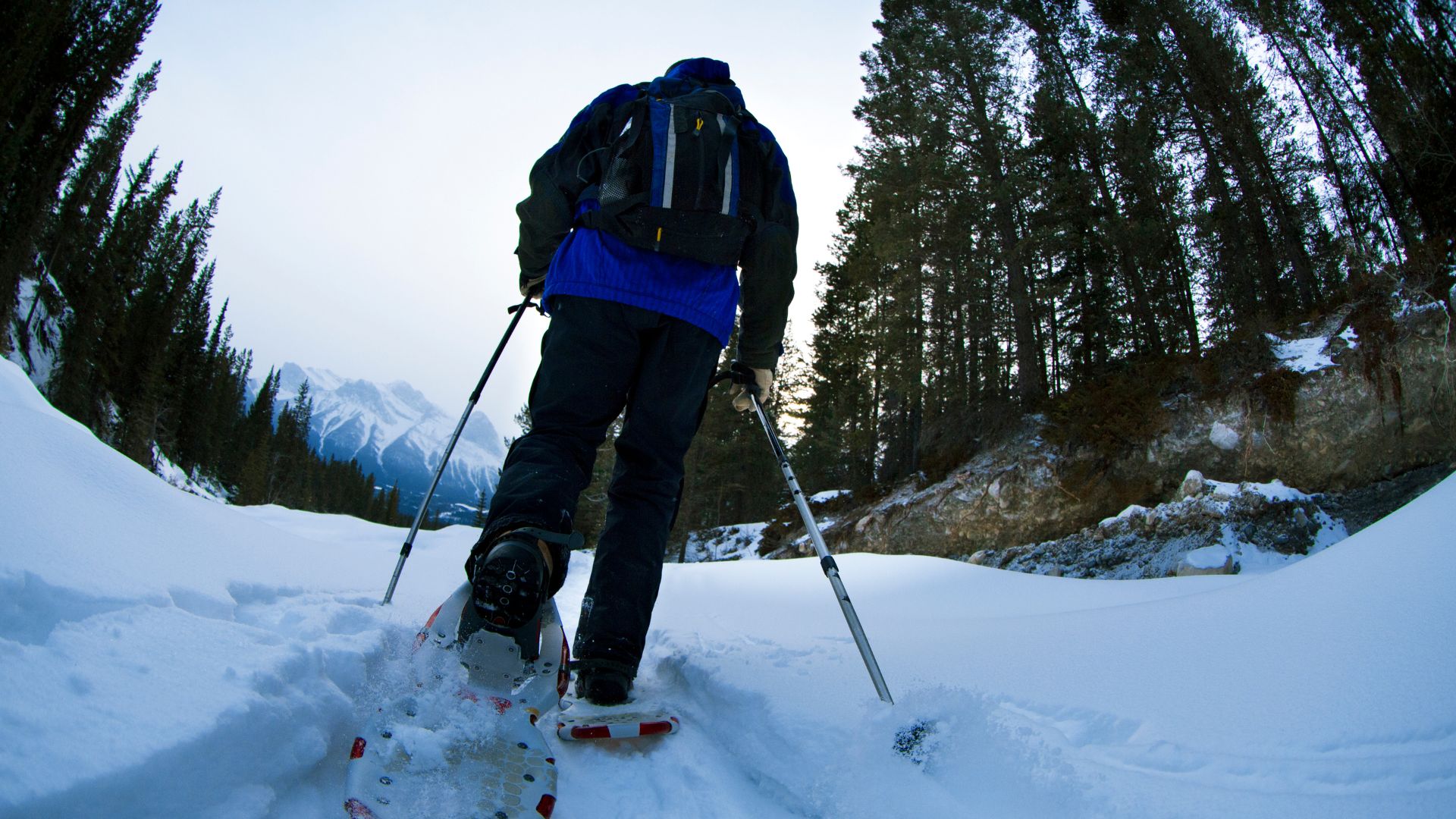 A man dressed for winter snowshoes in the Rocky Mountains