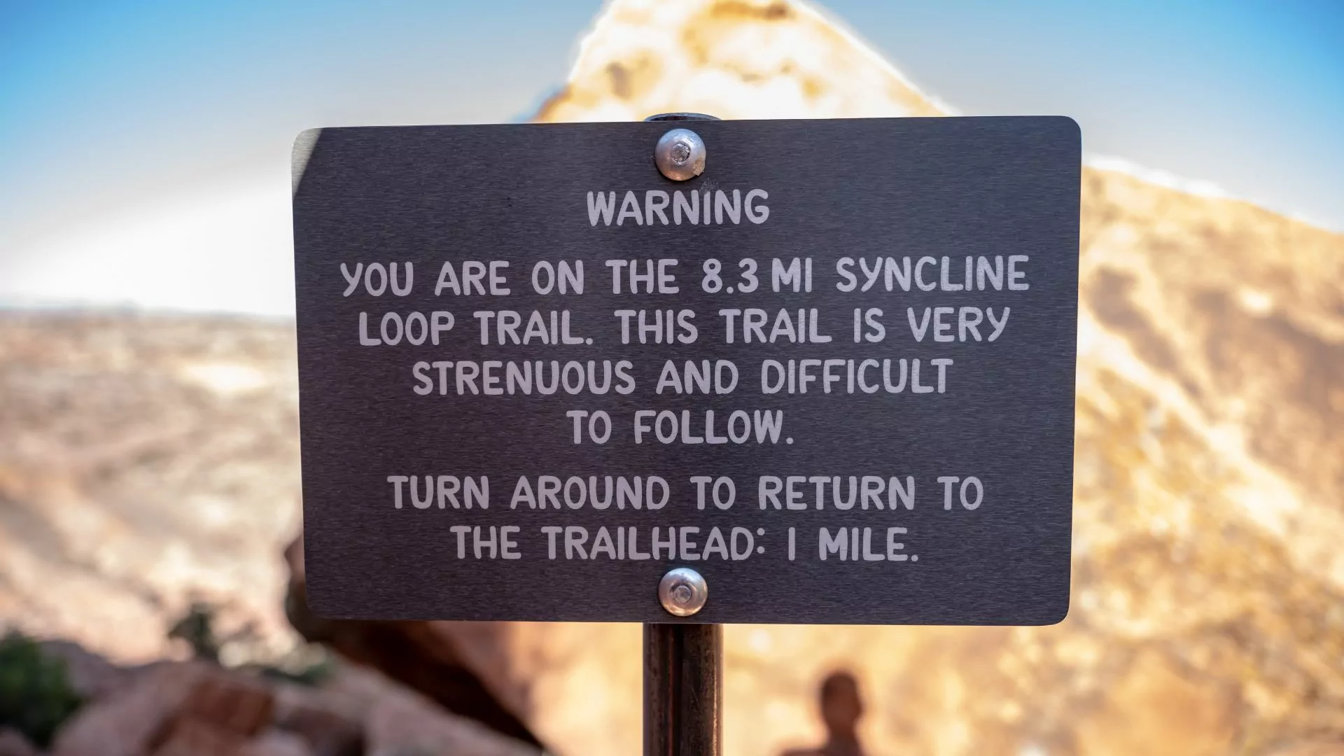 Warning sign on the Syncline Loop in Canyonlands National Park notes trail is strenuous