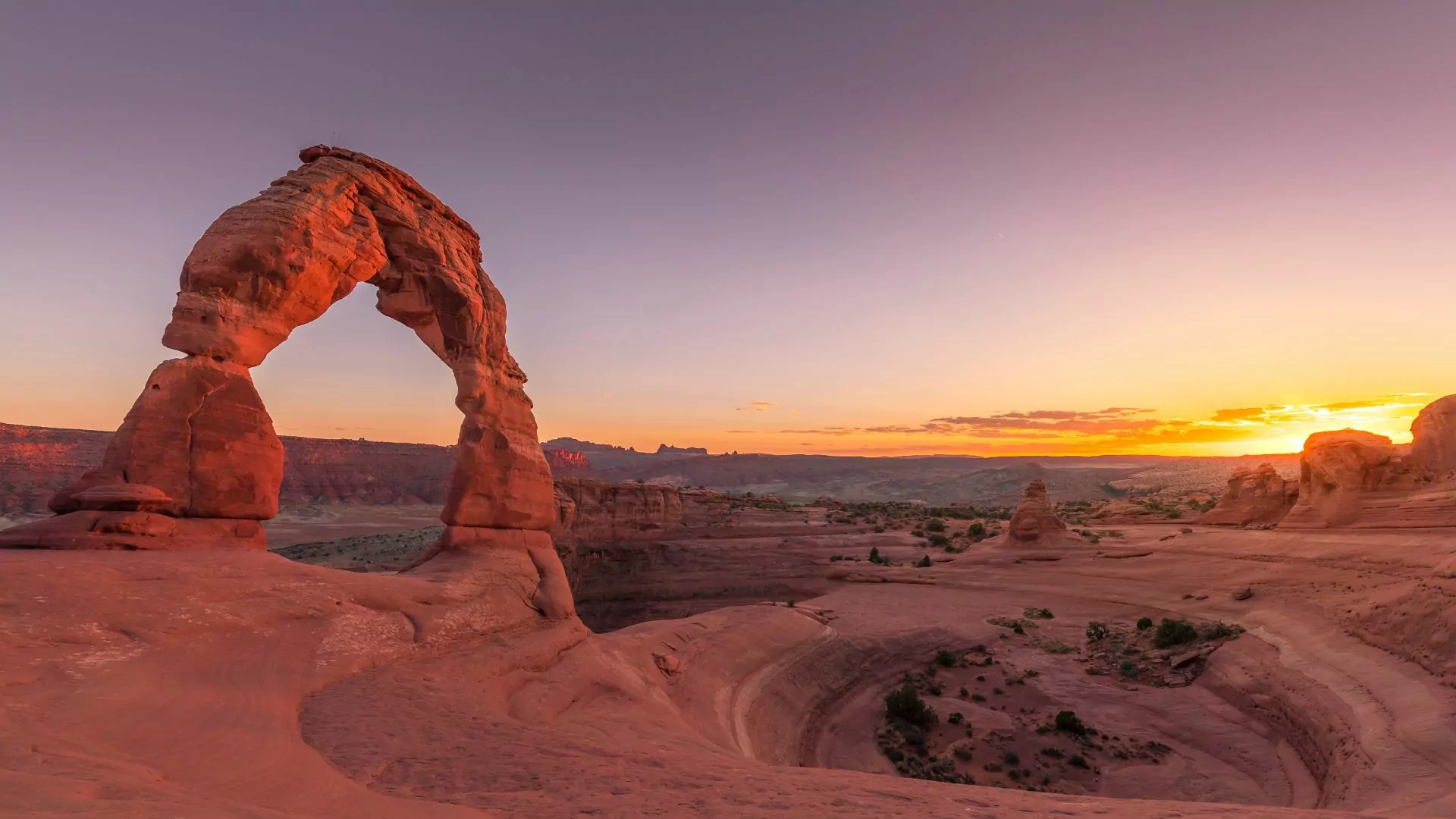Delicate Arch in Arches National Park dominates the sunrise skyline