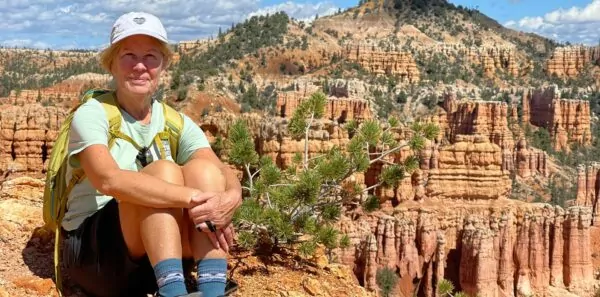 Hiker sits in front of a scenic view in Bryce National Park