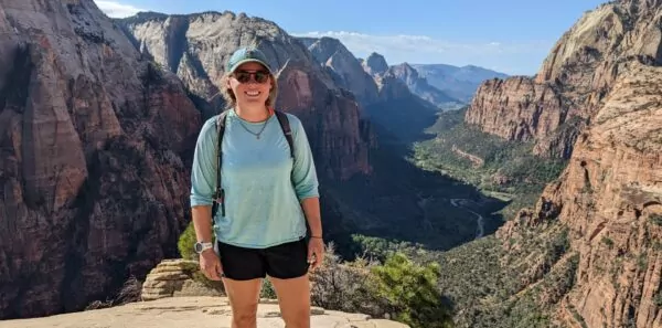 Zion National Park visitor stands at a viewpoint above the main canyon