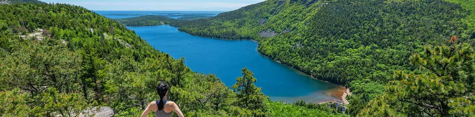 Woman enjoying the view of Jordan Pond in Acadia National Park, Maine