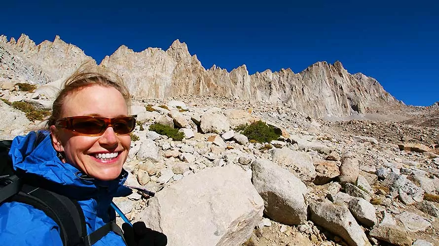 Woman hiker smiling at camera in the Sierra Nevada Mountains, California