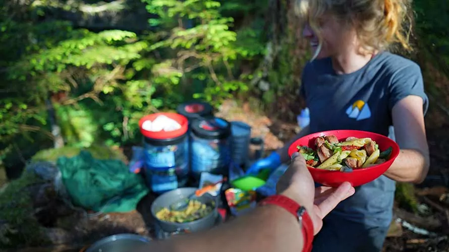 Wildland Trekking guide serving dinner in the Enchanted Valley, Washington