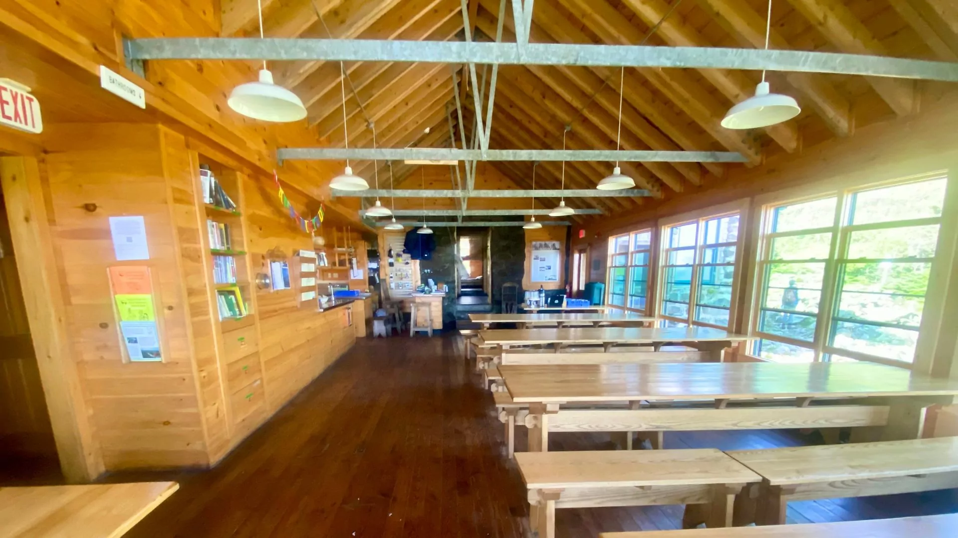 AMC hut common room/dining room with family style wooden tables and benches