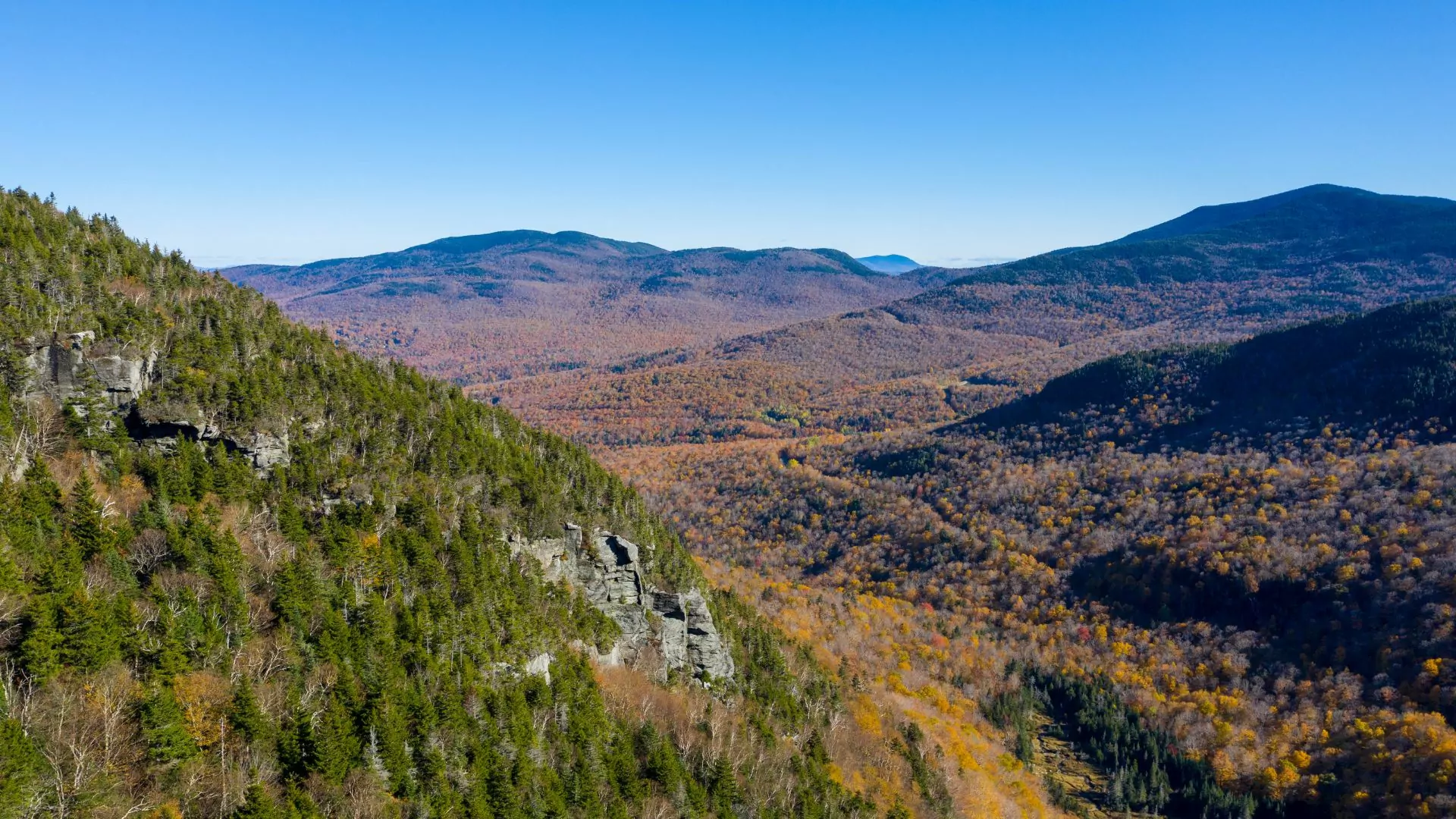 The mountain pass of Smuggler's Notch Vermont boasts colorful fall foliage