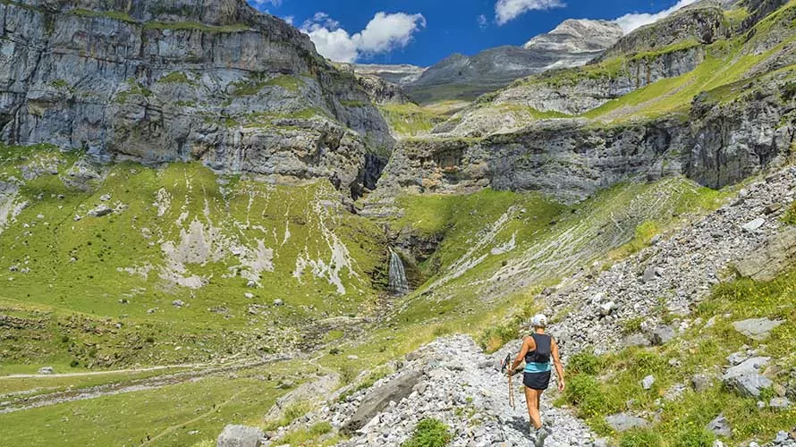 Woman doing sport and hiking in Ordesa National Park, in the Pyrenees, Huesca, Spain