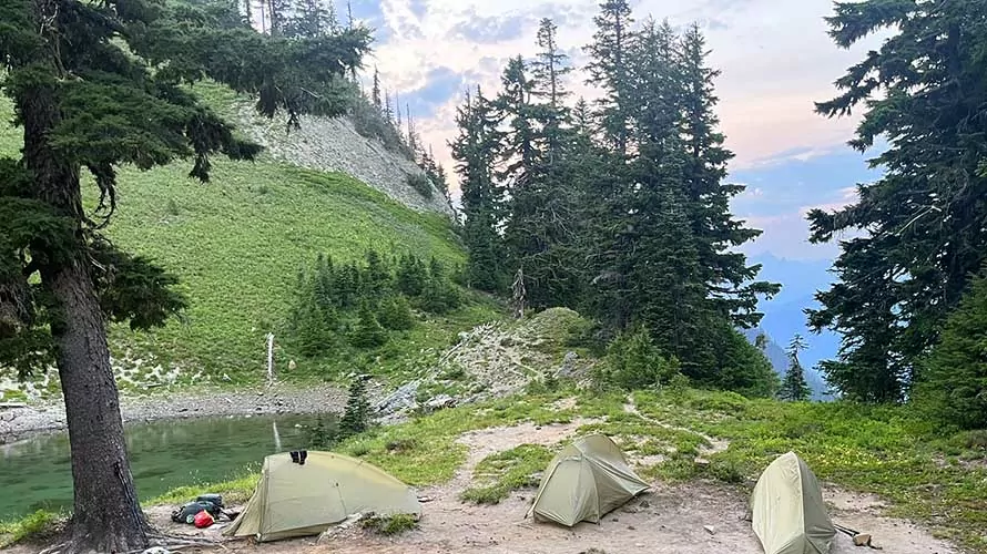 Tents set up near an alpine lake in the Goat Rocks Wilderness, Washington