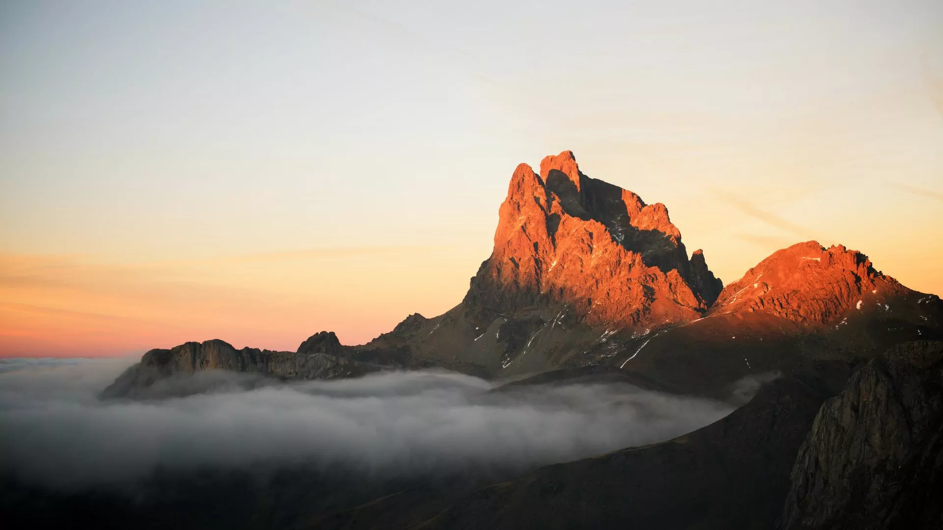 Mist swirls around a rocky peak in the Pyrenees mountains