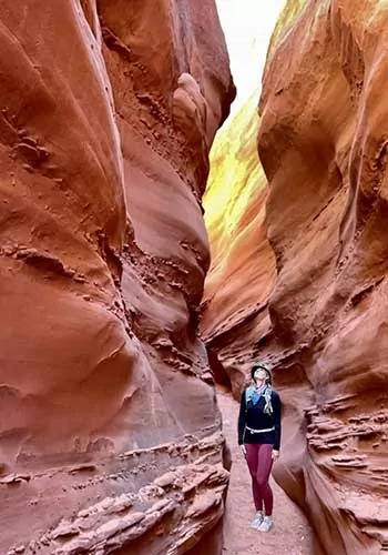 Hiker in a slot canyon in Grand Staircase-Escalante National Monument, Utah