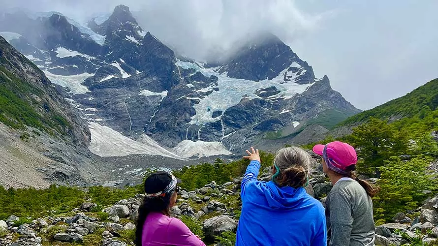 Guide pointing out terrain features to clients in Torres del Paine, Chile