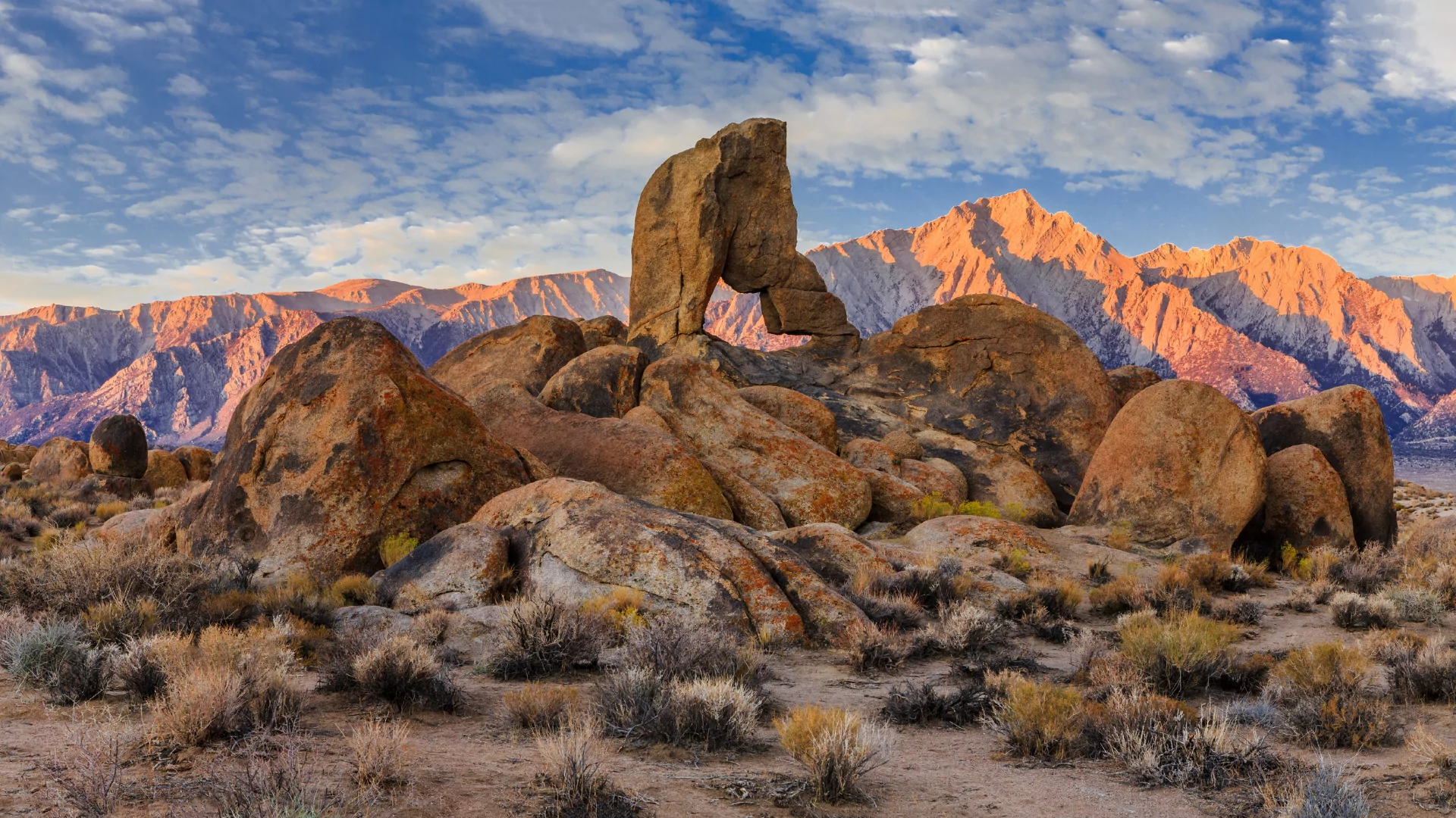 A rock arch rises our of the desert of the alabama hills 