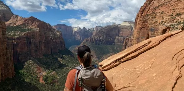 A hiker looks out at Zion National Park