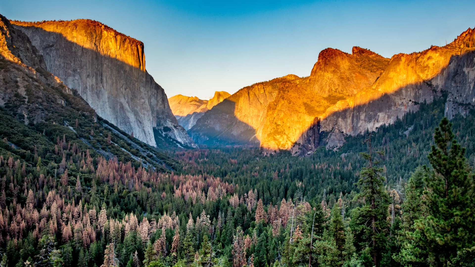 Sun baths the granite walls of yosemite valley in the fall