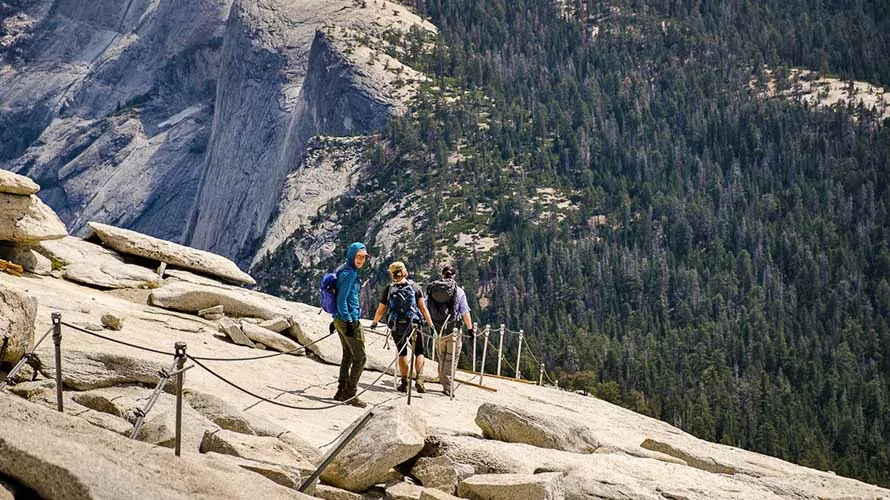 Wildland Trekking guests descending "The Cables" on Half Dome