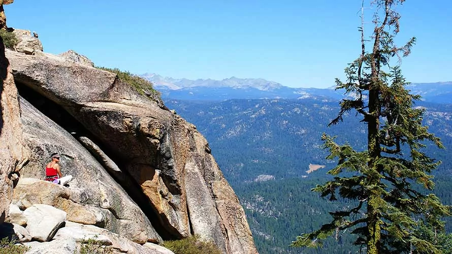 Woman climber sitting at crag in the Sierra