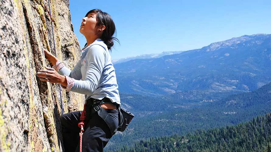 Rock climber ascending a vertical granite face in the Sierras