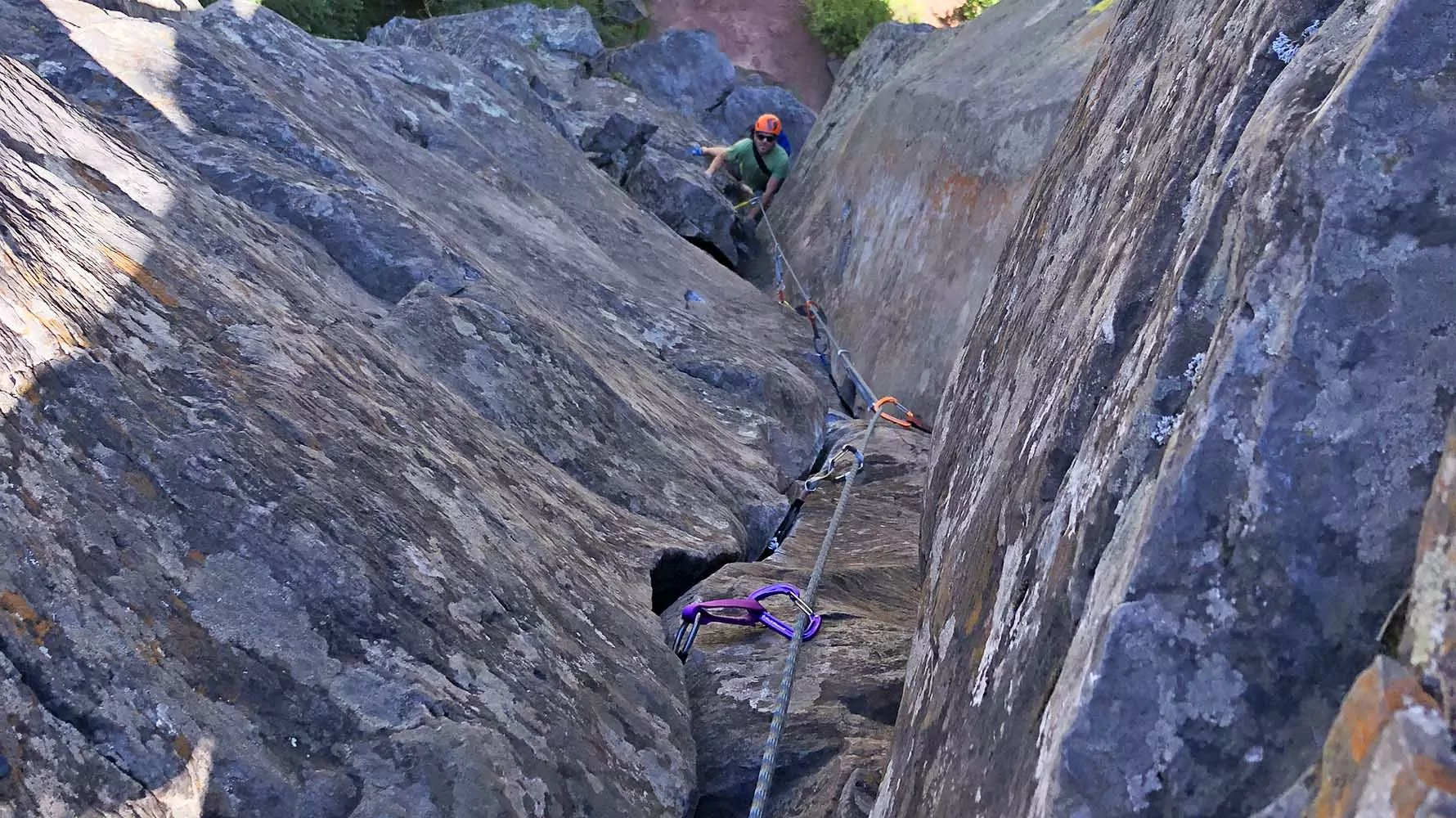 Rock climber following on a traditional route