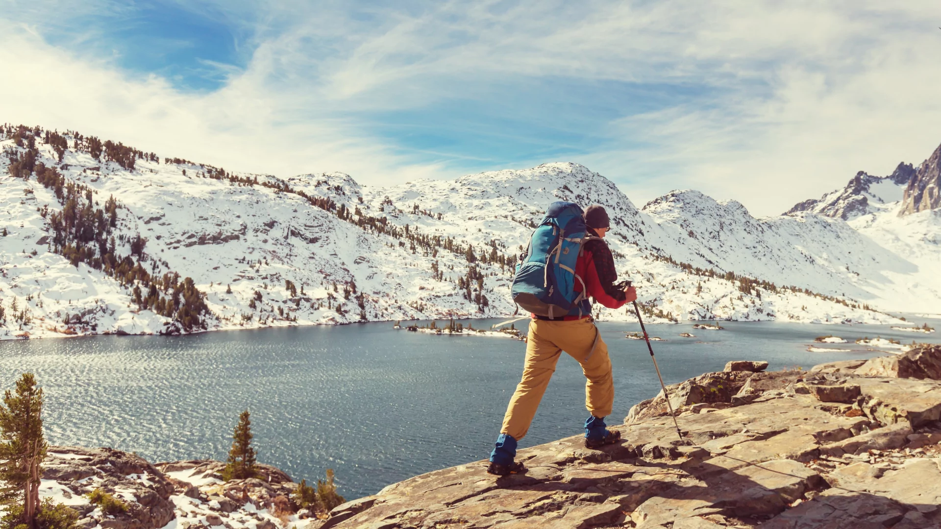 A backpacker treks through the snowy Sierra Nevada mountains