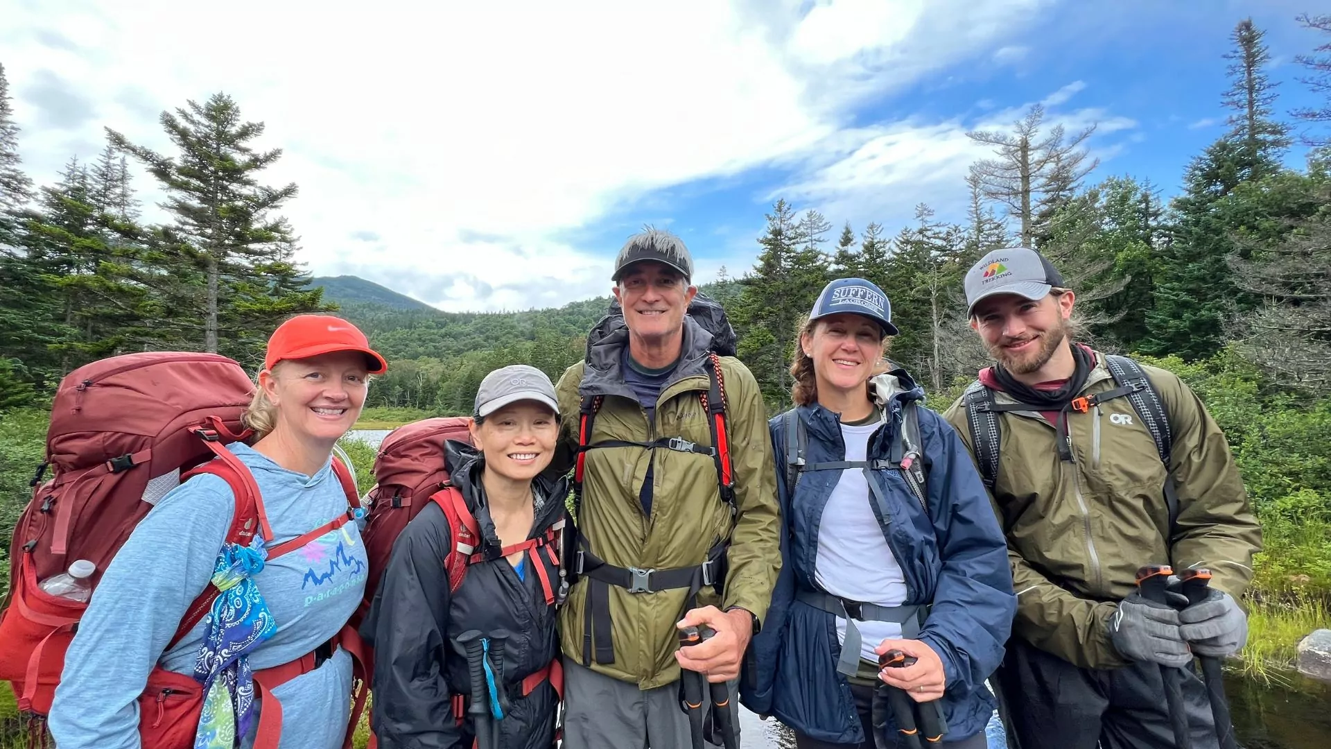 A group of backpackers poses together