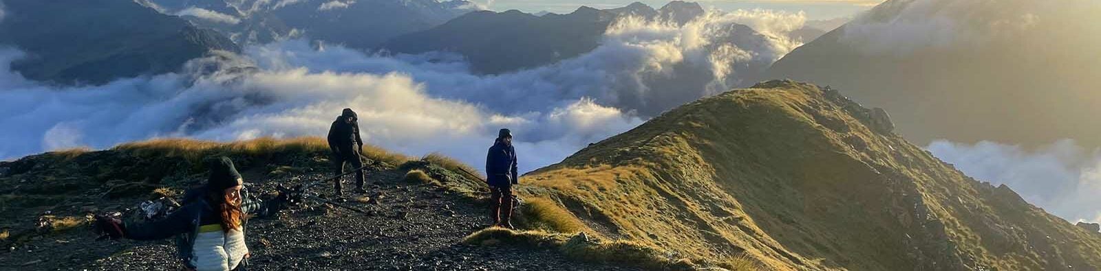 Hikers at sunrise high in the New Zealand Alps