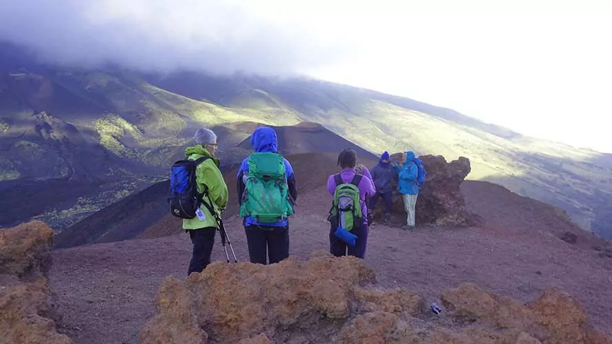 Hikers standing atop Mt. Stromboli volcano