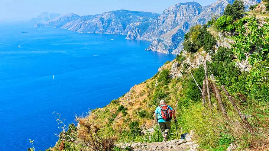 Hiker on the Path of Gods trail, Amalfi Coast, Italy, overlooking Tyrrhenian Sea