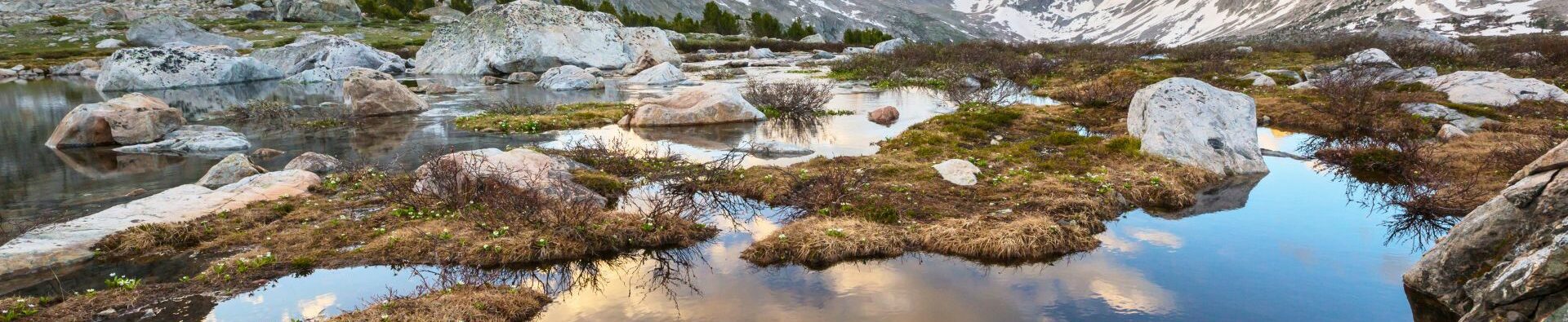 The sky reflects in an alpine lake in the wind river mountains
