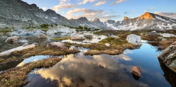 The sky reflects in an alpine lake in the wind river mountains