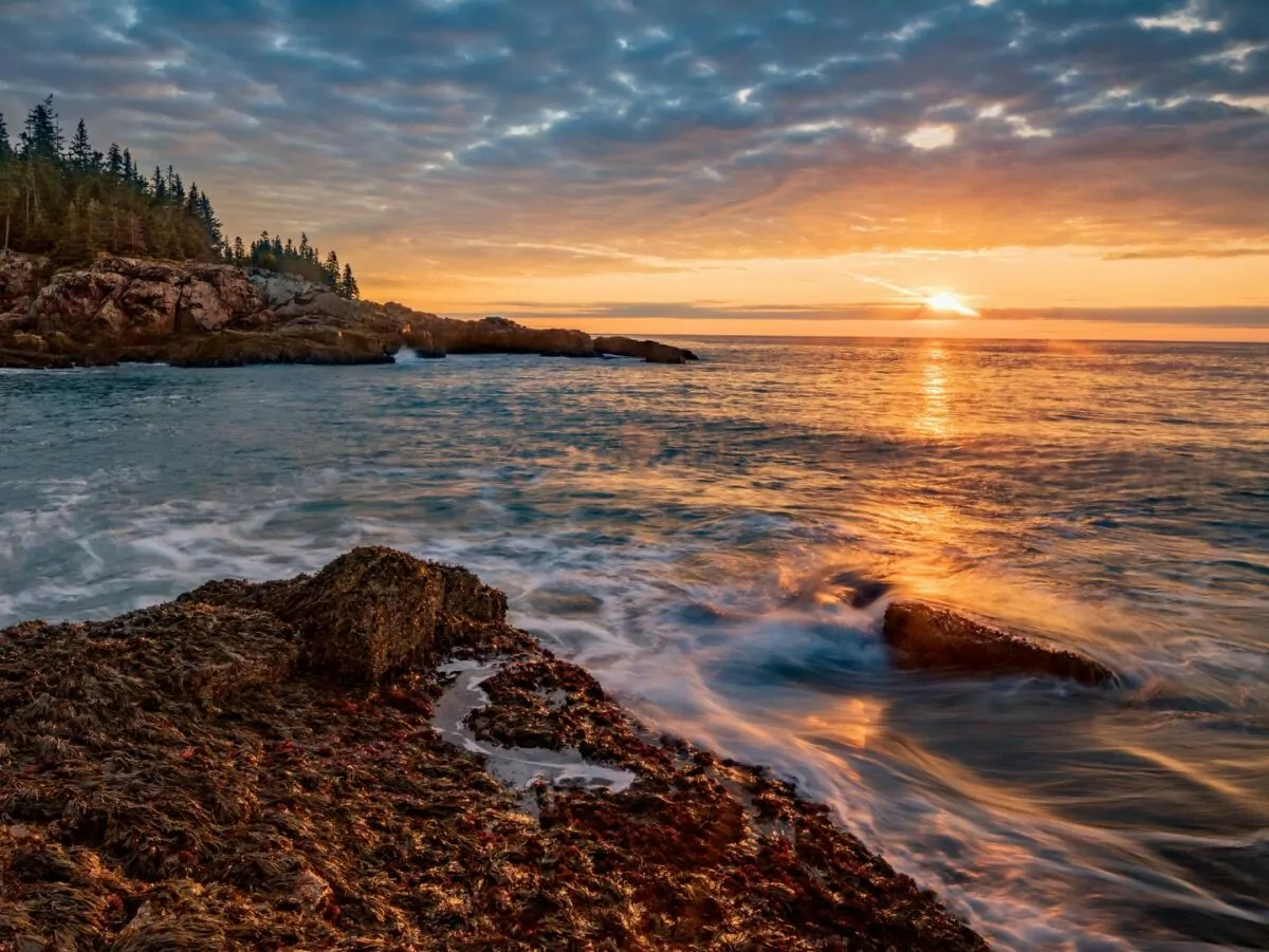 The sun sets over the atlantic ocean at Acadia National Park
