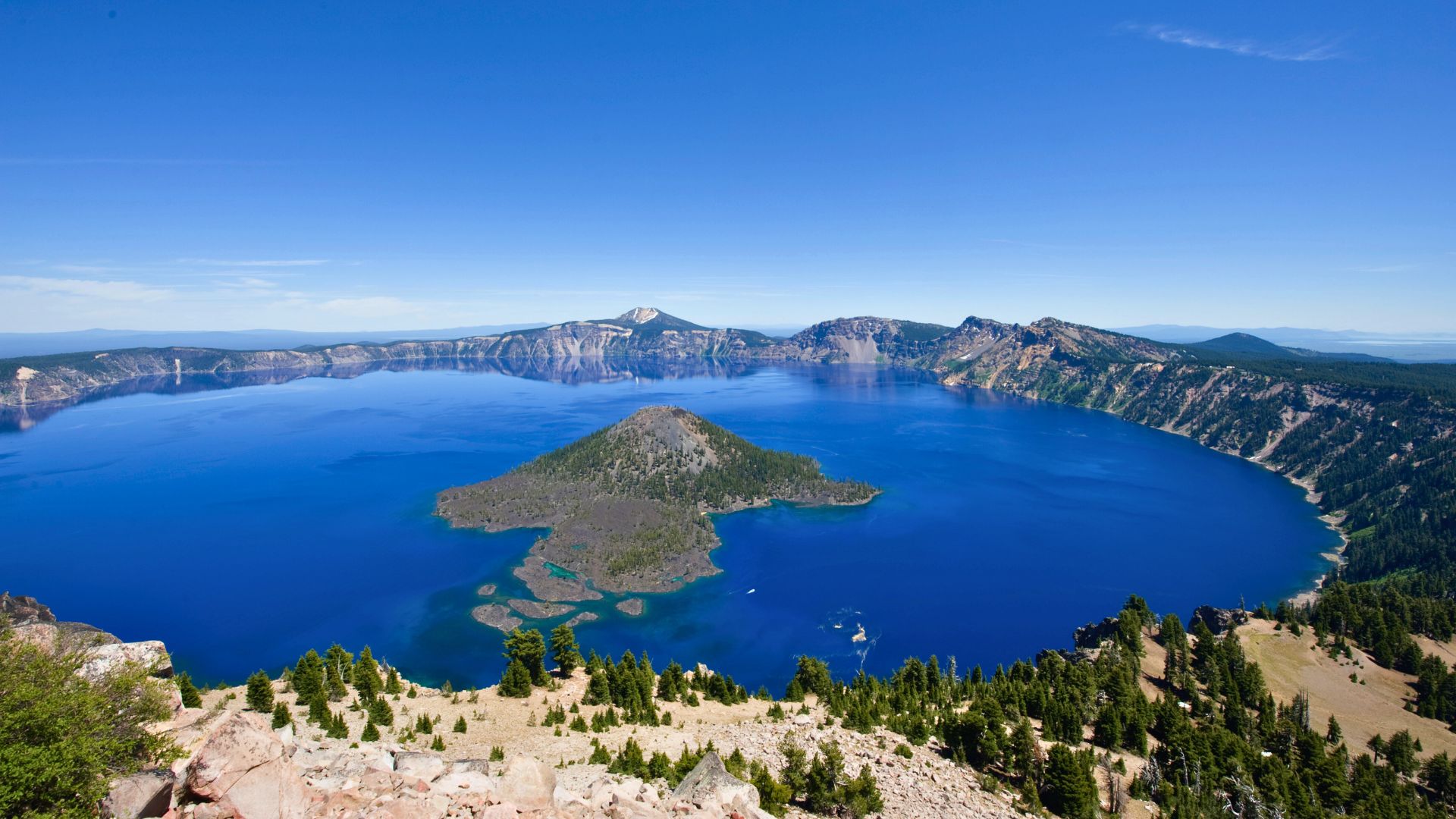 Crater Lake in Oregon is a deep blue with a small green island in the middle