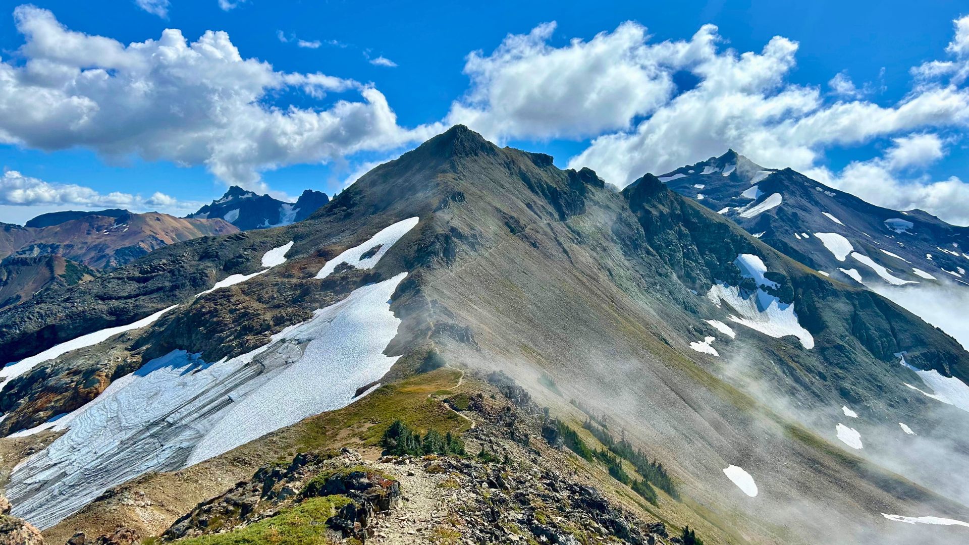 A rocky and snowy Knife's Edge Ridge stretches away in the Goat Rocks Wilderness