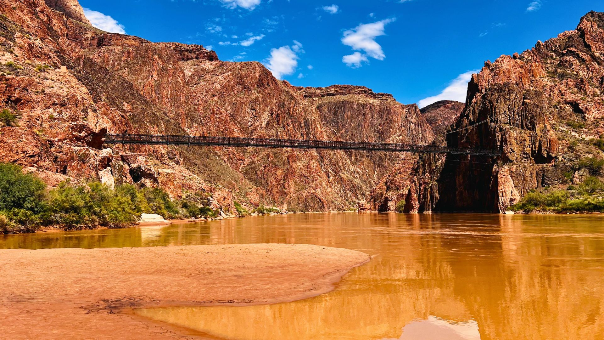 A bridge stretches over the Colorado River in the Grand Canyon