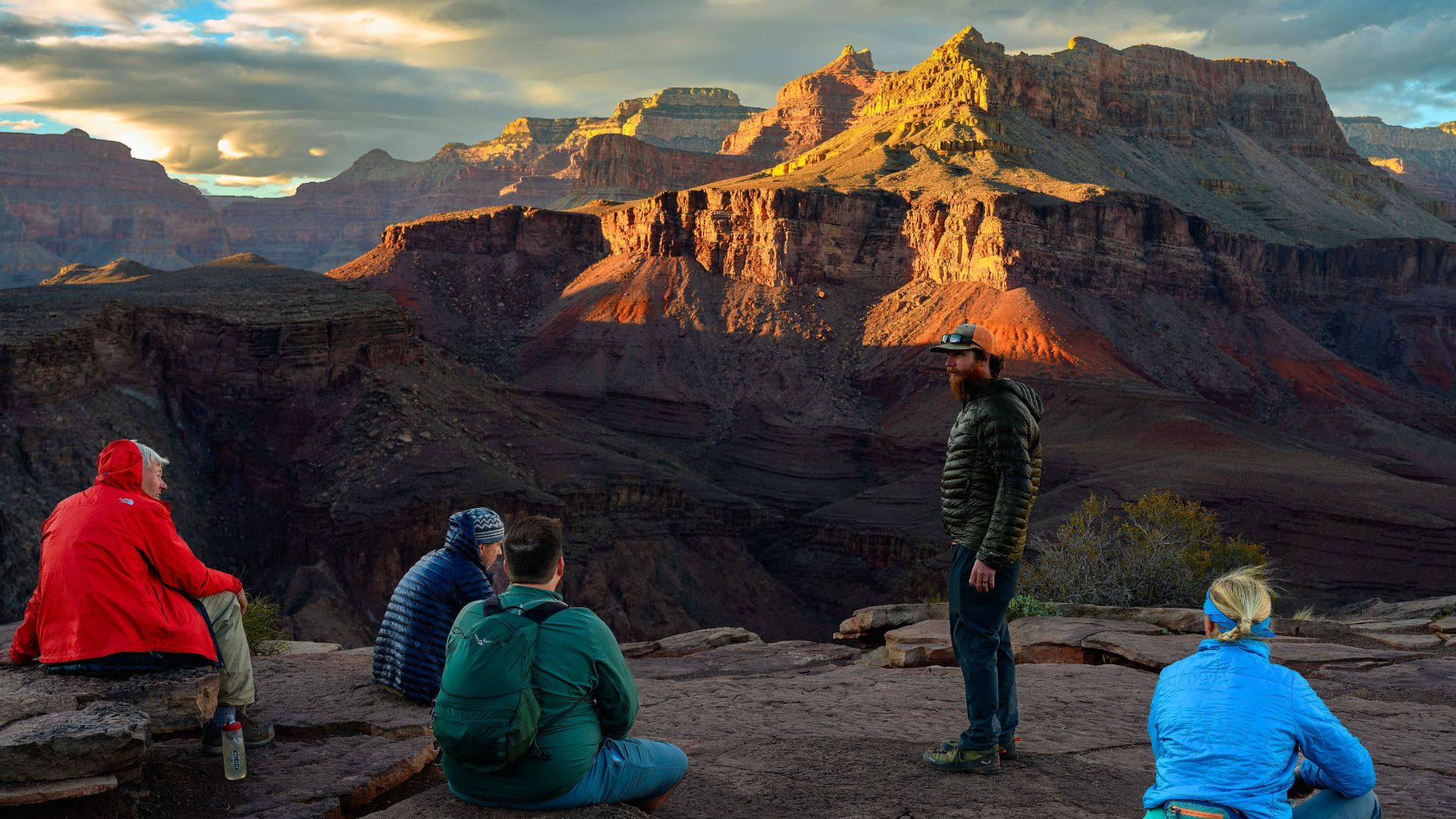 A group sits in the Grand Canyon looking out at the view