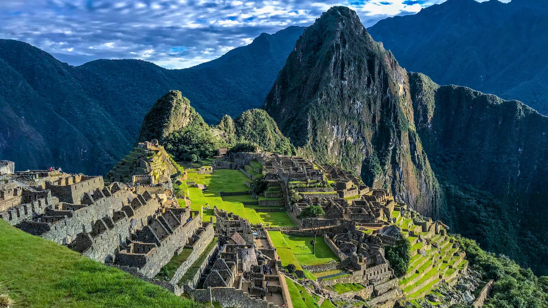 The Inca ruin of Machu Picchu stands in the distance at the end of the Inca Trail in Peru