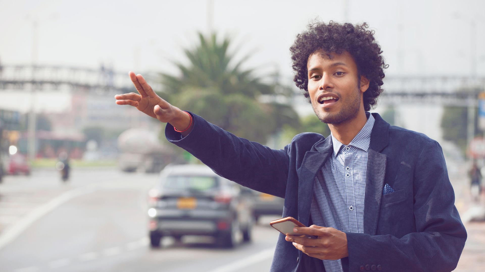 A man hails a car in an international destination