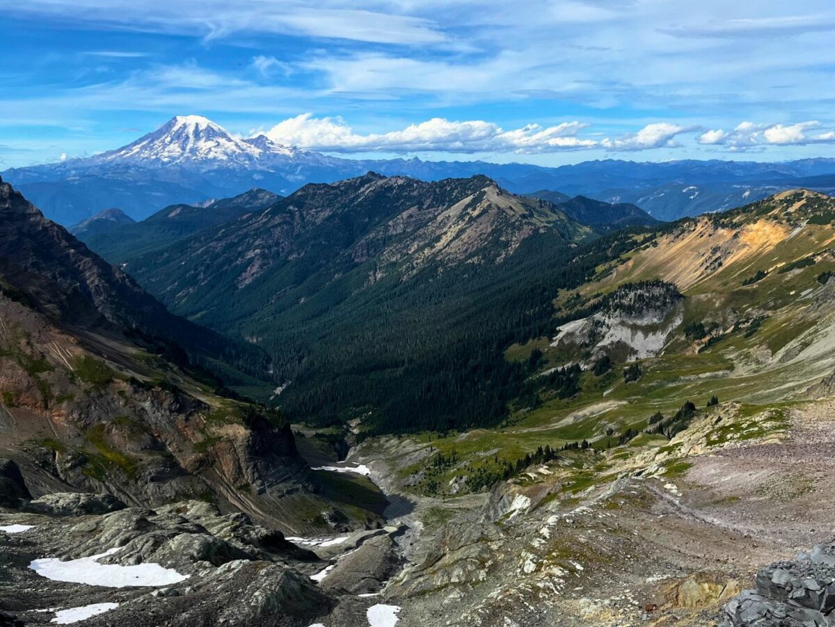 Snow capped mountains rise in the distance in the Goat Rocks