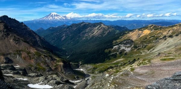 Snow capped mountains rise in the distance in the Goat Rocks