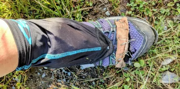 A ripped hiking shoe shows evidence of repair