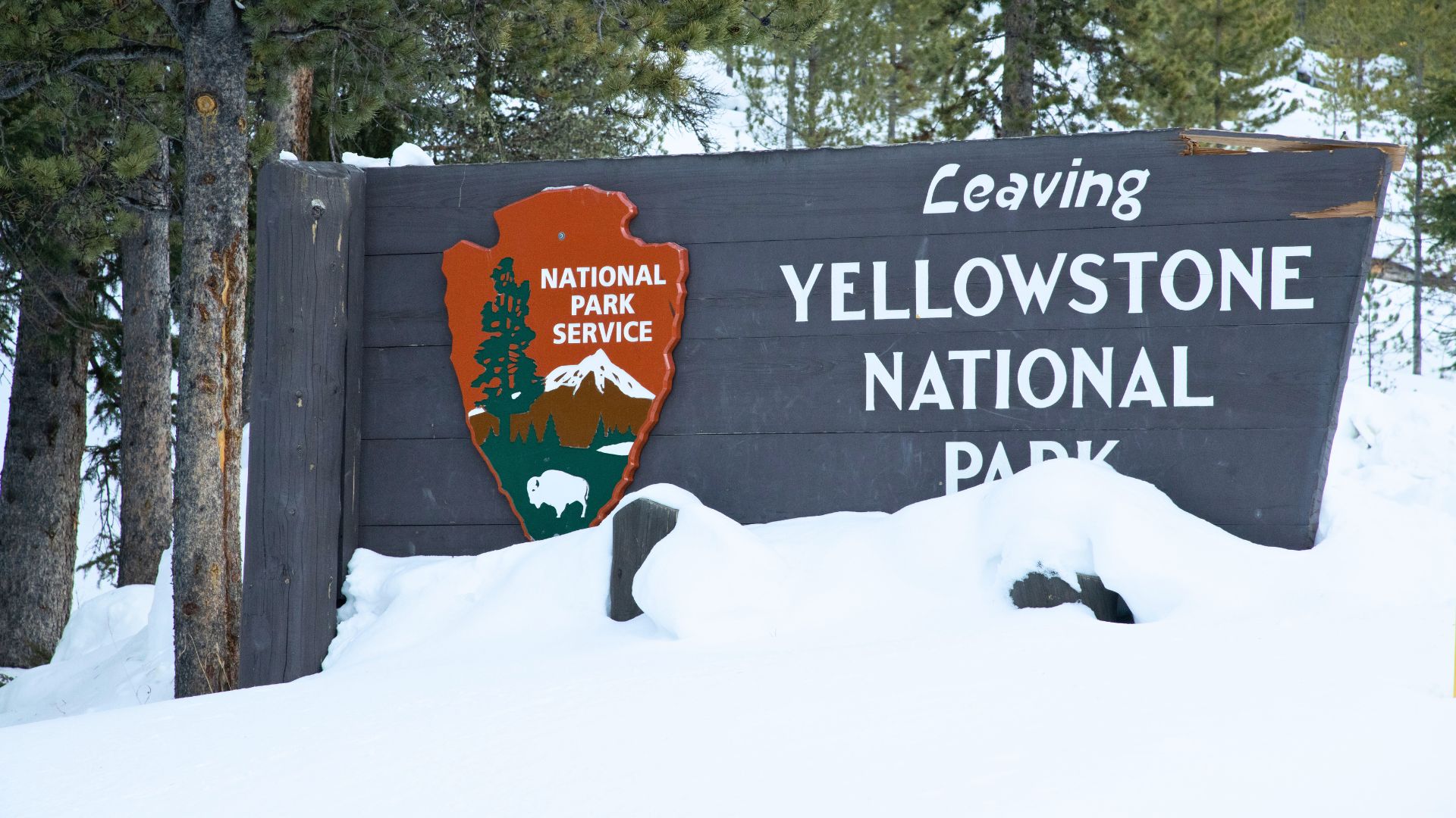 The Yellowstone National Park sign is buried in snow