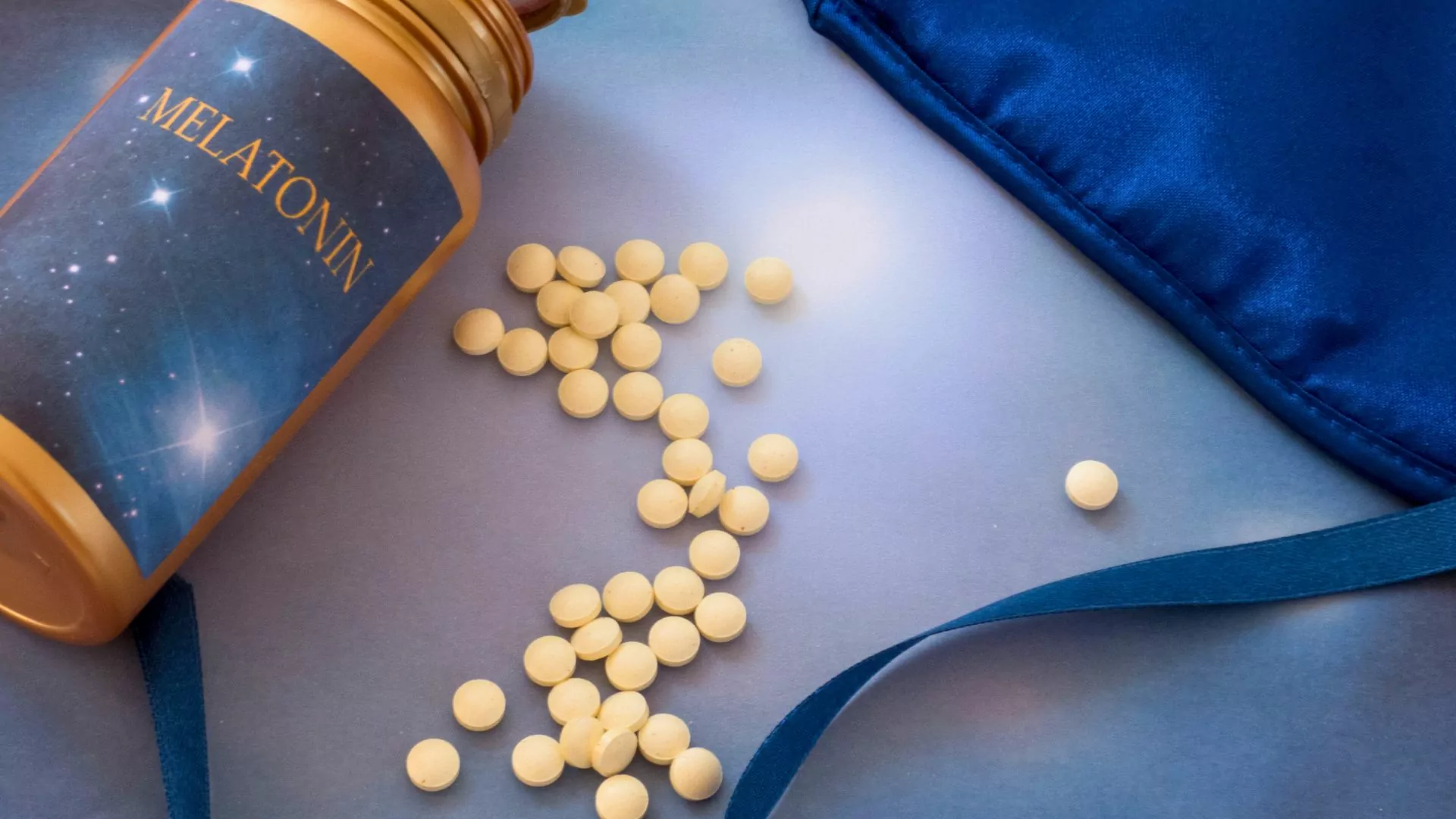 Pills spill out of a bottle of melatonin