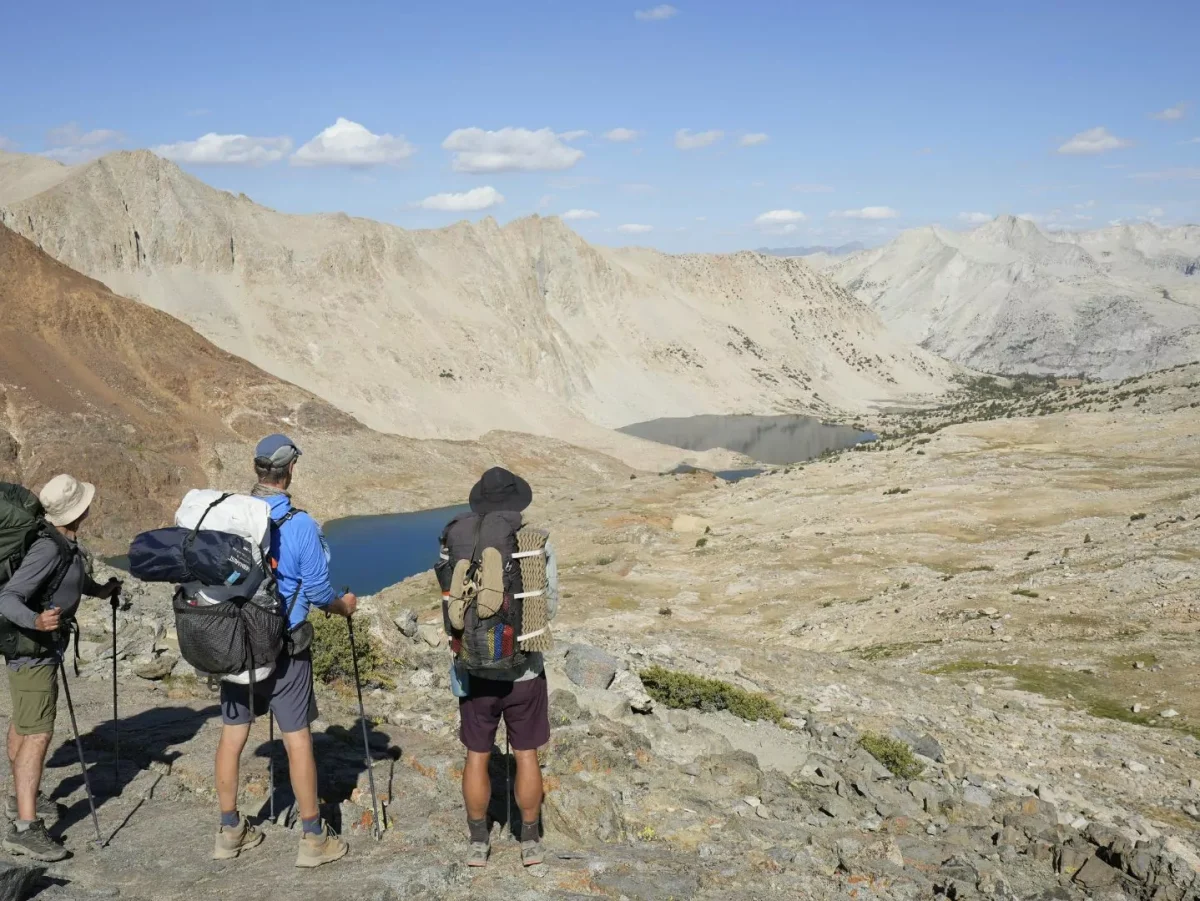 Three backpackers look at the mountains|Backpacking food|A guide cooks backpacking food|Tortillas|Instant oatmeal||Snack mix|Trail mix|Ramen