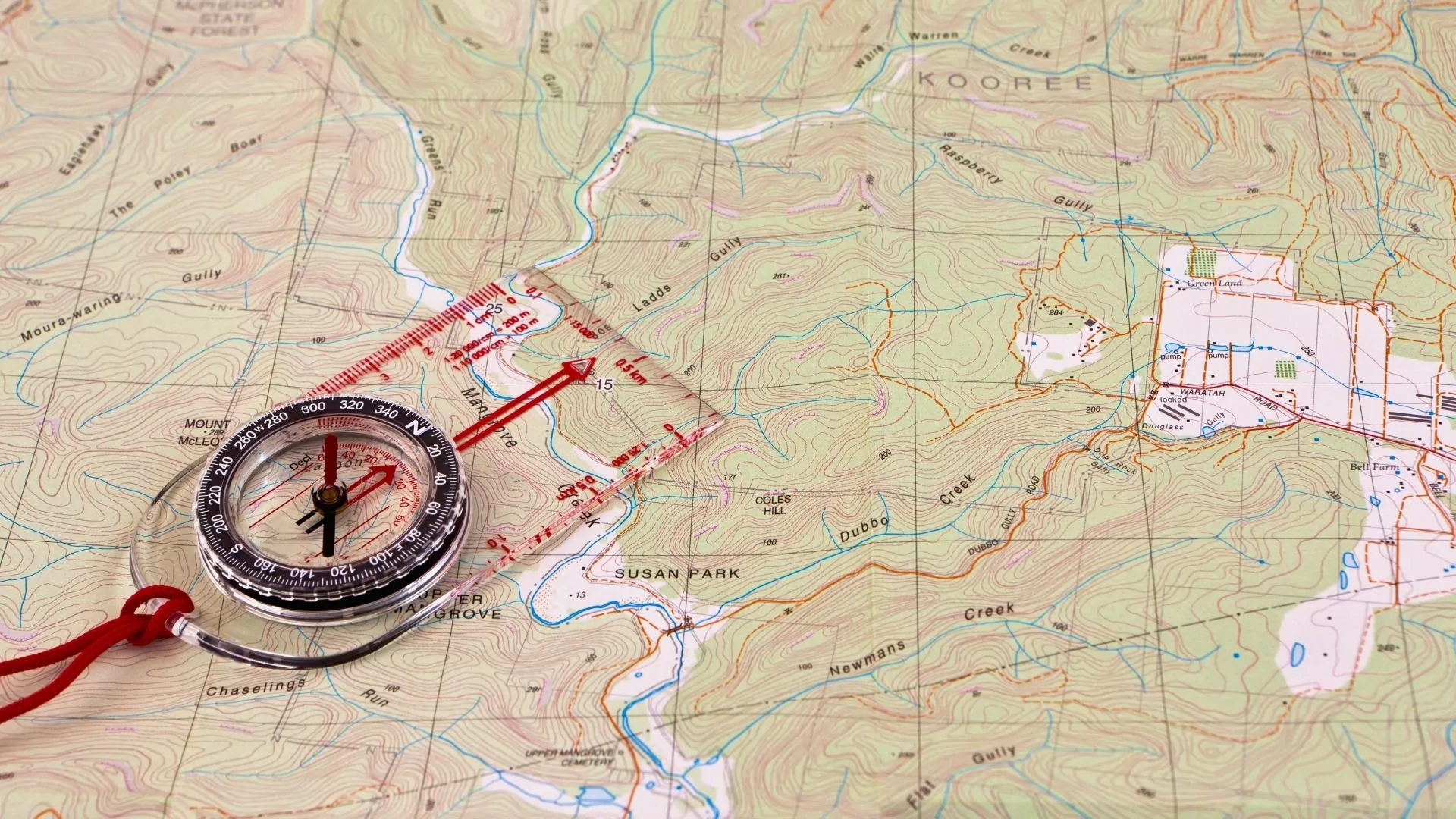 A compass sits on top of a map