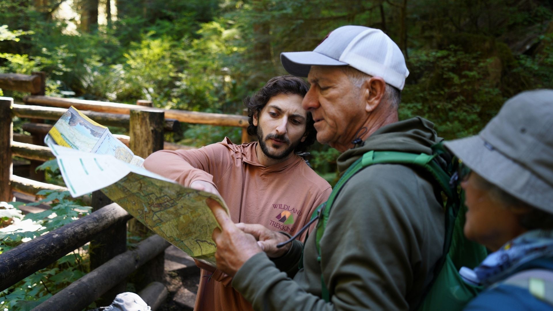 A guide points to a map