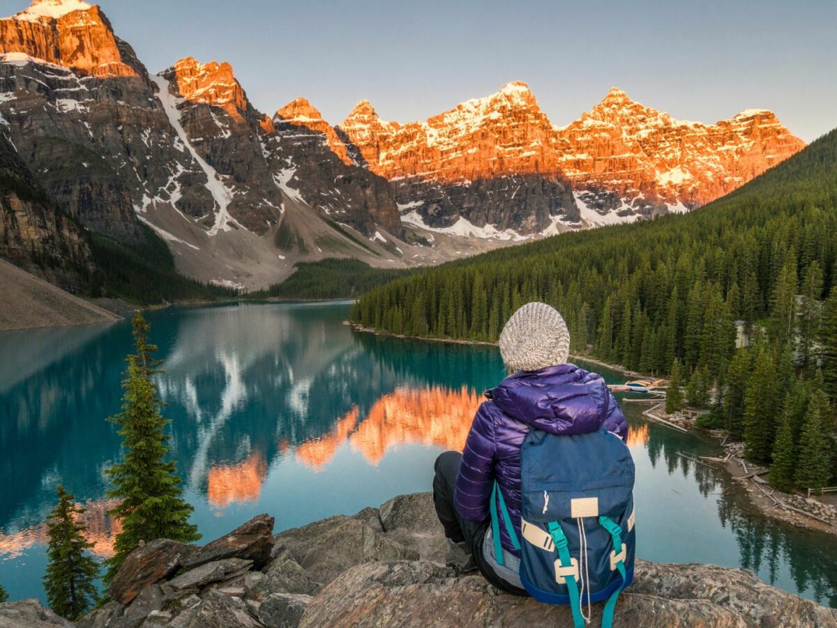 A hiker sits overlooking a lake in Banff National Park