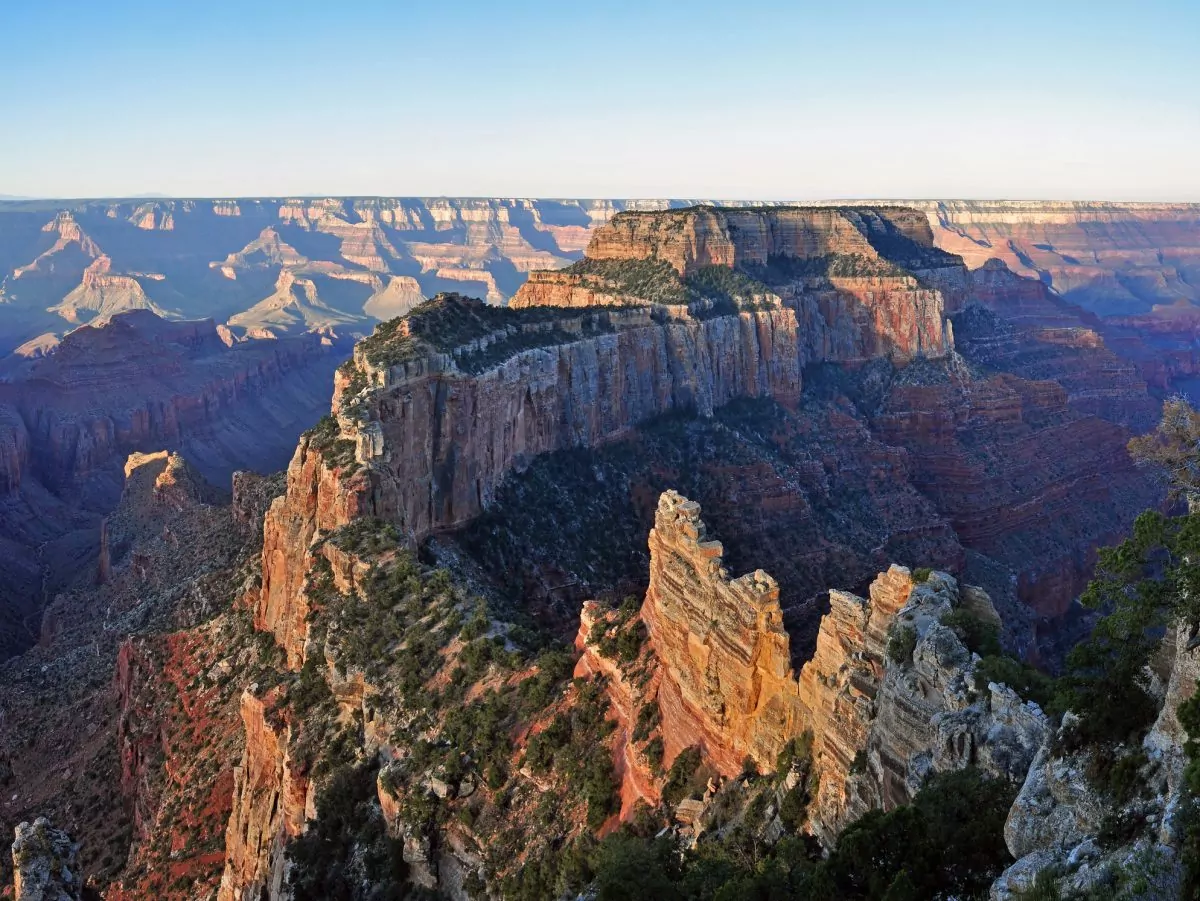 Cape Royal on the North Rim provides a panorama up, down, and across the canyon. With seemingly unlimited vistas to the east and west, it is popular for both sunrise and sunset. The sweeping turn of the Colorado River at Unkar Delta is framed through the natural arch of Angels Window. Look for the Desert View Watchtower across the canyon on the South Rim. This popular viewpoint is accessible via a paved, level trail. Cape Royal and Point Imperial are reached via a winding scenic drive. The trip to both points, with short walks at each and several stops at pullouts along the way, can easily take half a day. Lodging and food service facilities on the North Rim of Grand Canyon National Park are open for the summer season between May 15 and October 15 of each year. Grand Canyon Lodge North Rim, a Forever Resorts property, and Grand Canyon Trail Rides operate during this 5 month period. For more information visit: http://www.nps.gov/grca/planyourvisit/directions_n_rim.htm NPS Photo by Michael Quinn