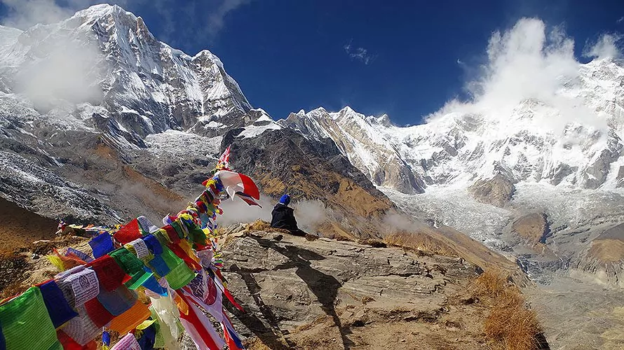 Nepalese flags on rocky cliff