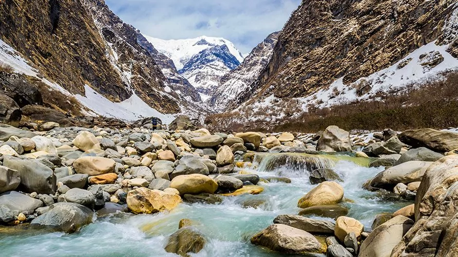 Alpine stream with mountains