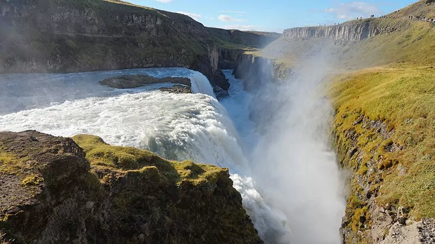 Raging waterfall with grassy cliffs