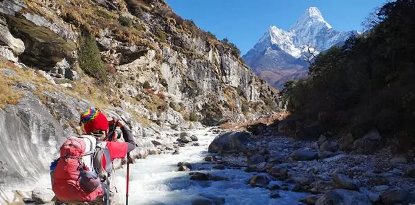 Hiker walking through a mountain valley